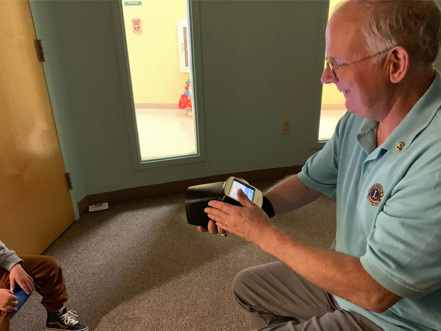 Fred Rieger conducting a vision screening with the Spot vision screener